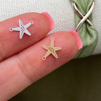 14kt gold filled and sterling silver starfish connectors for permanent jewelry displayed on fingertips